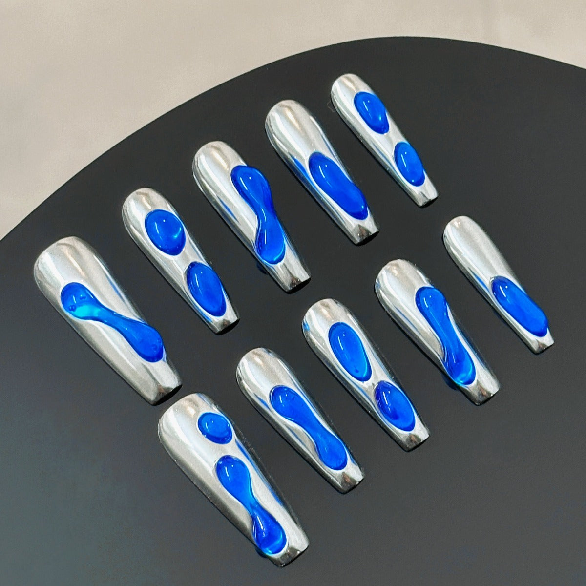 chrome nails with blue accent liquid 3d design long coffin shaped front view ten pieces